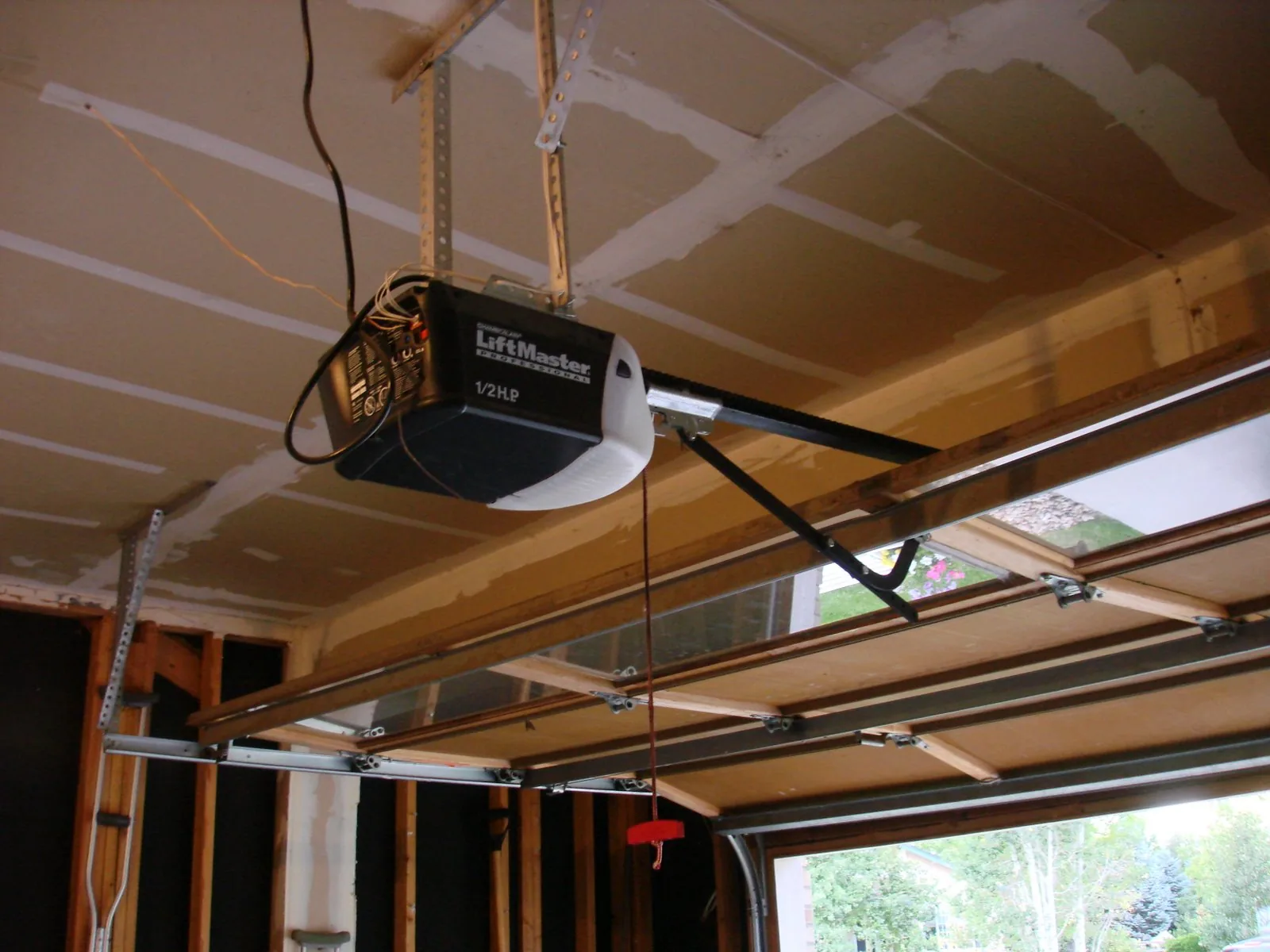 A LiftMaster garage door opener mounted on the ceiling rail
