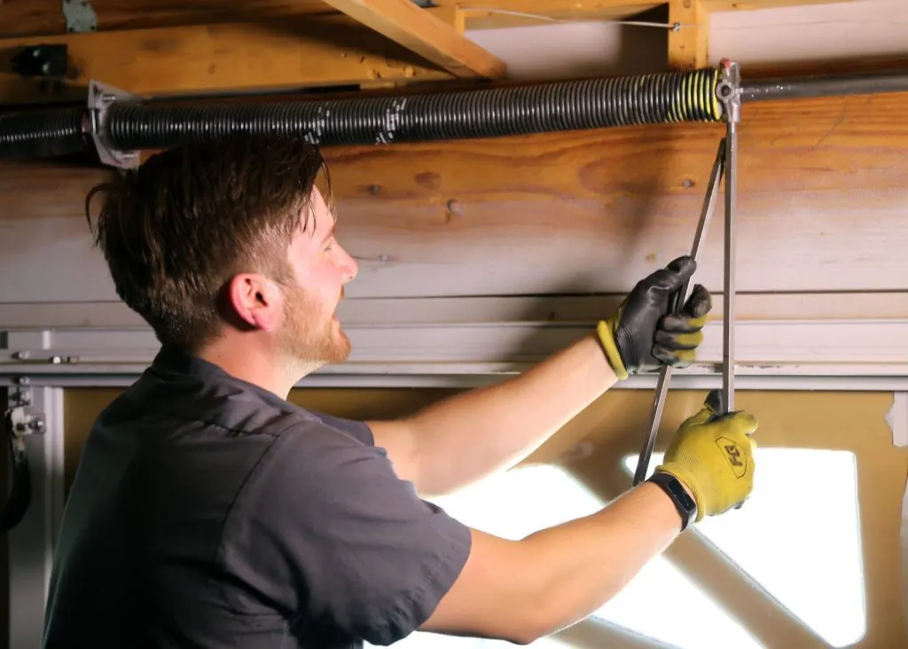 KC Garage Door Repair Buckner, MO technician fixing garage door spring for reliable garage door repair services.